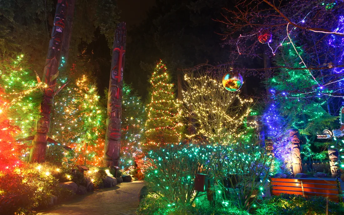 Trees and totem poles illuminated during Canyon Lights at Capilano Suspension Bridge Park